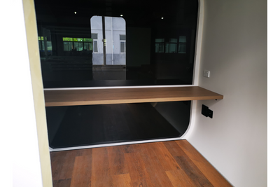 LED Privacy SPACEE pod with black tinted glass and desk fixture.
