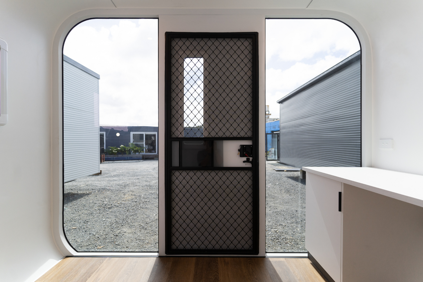 backyard office space with natural light through doors and black-out privacy glass