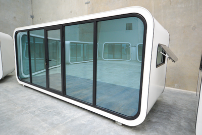 BigBox Spacee design exterior in white with mirrored window doors and black door frame with lockable front door. and open side window.