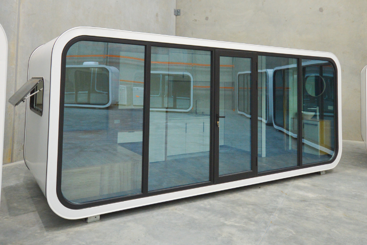 WhiteHouse Spacee design exterior in white with mirrored glass doors and black door frames with lockable door and mirrored side window with black window frame.
